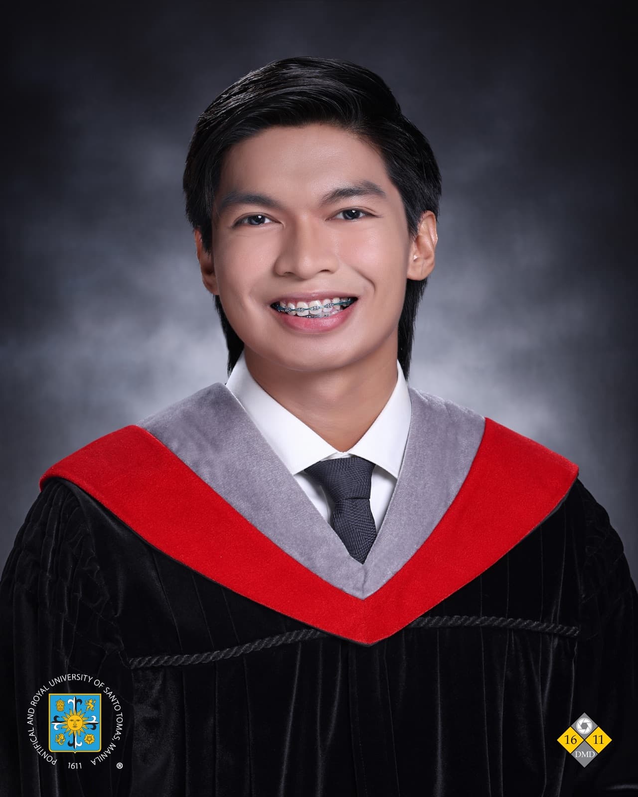 Josh Kenn Viray in graduation attire standing outdoors after graduating from UST